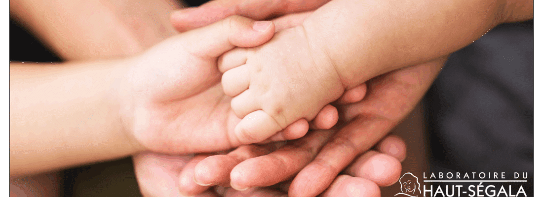 Mains d'adultes et d'un enfant superposées, symbolisant la protection et la douceur des soins du Laboratoire Haut-Ségala pour la famille.